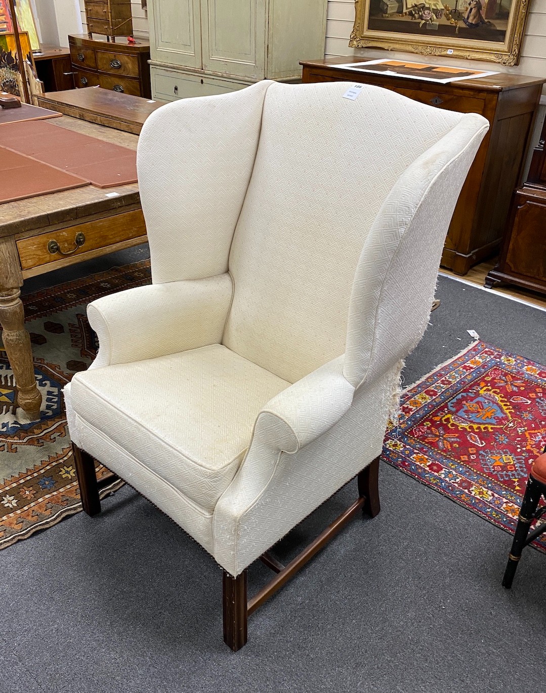 A George III style mahogany framed upholstered wing armchair, width 80cm, depth 64cm, height 122cm